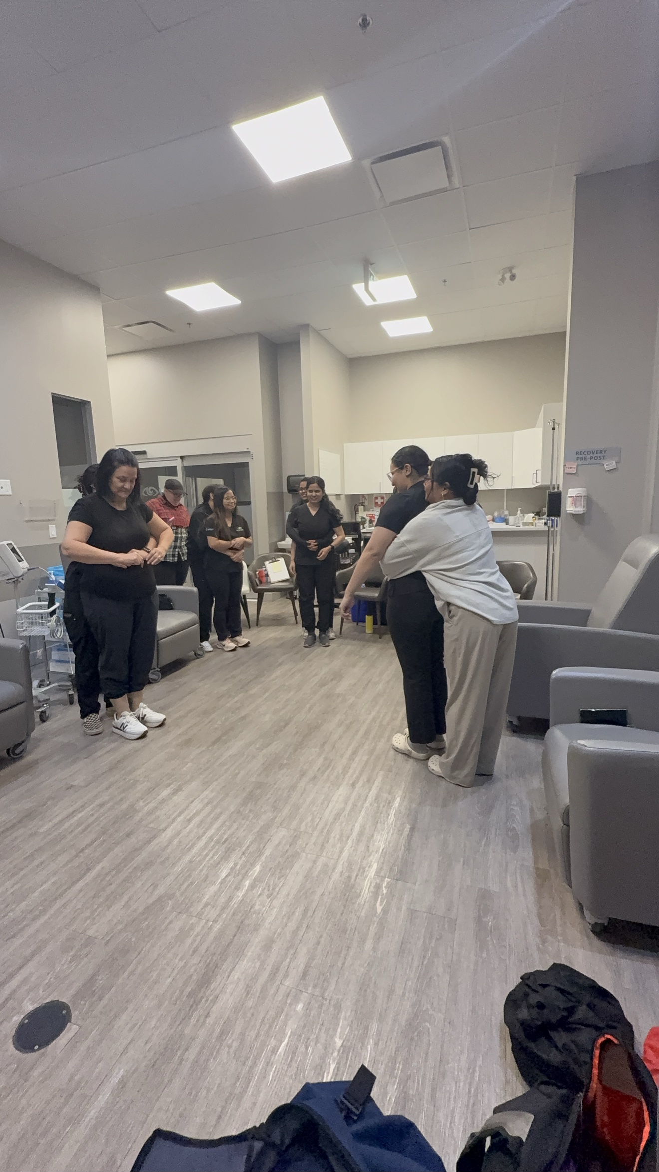 Students practising choking relief at an Academy first aid class